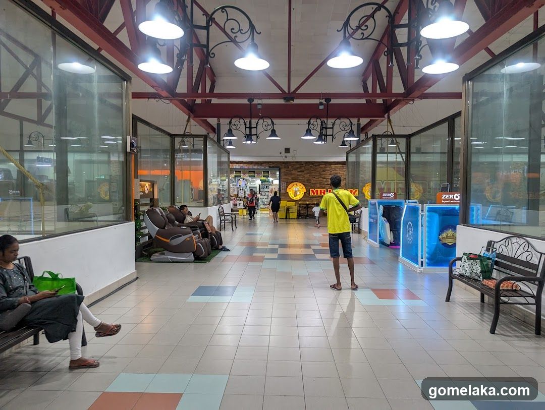 Shopping Mall Interior with Massage Chairs and Retail Displays