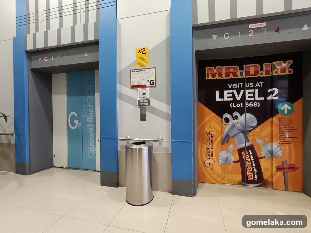 Interior elevator lobby with MR.D.I.Y. advertisement
