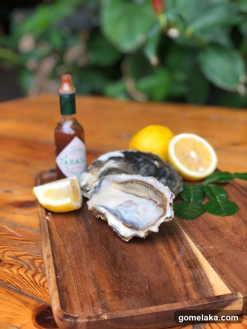 Oyster with lemon and hot sauce