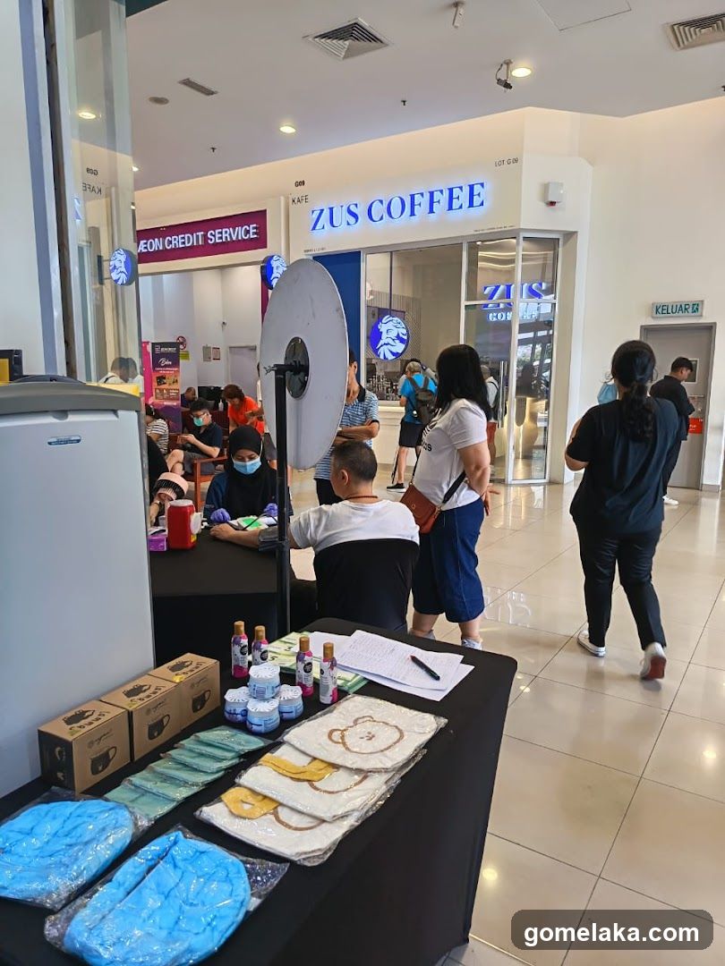 Interior of shopping mall with promotional stall