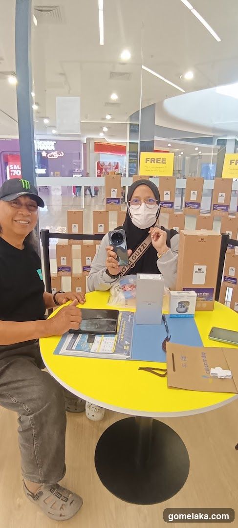 Two people at a retail display table