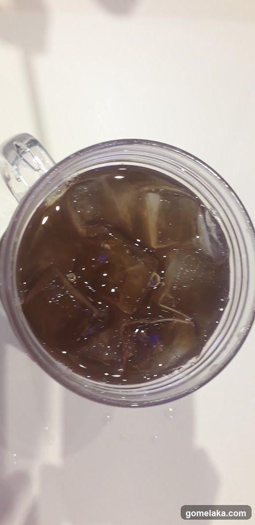 Iced beverage in transparent mug