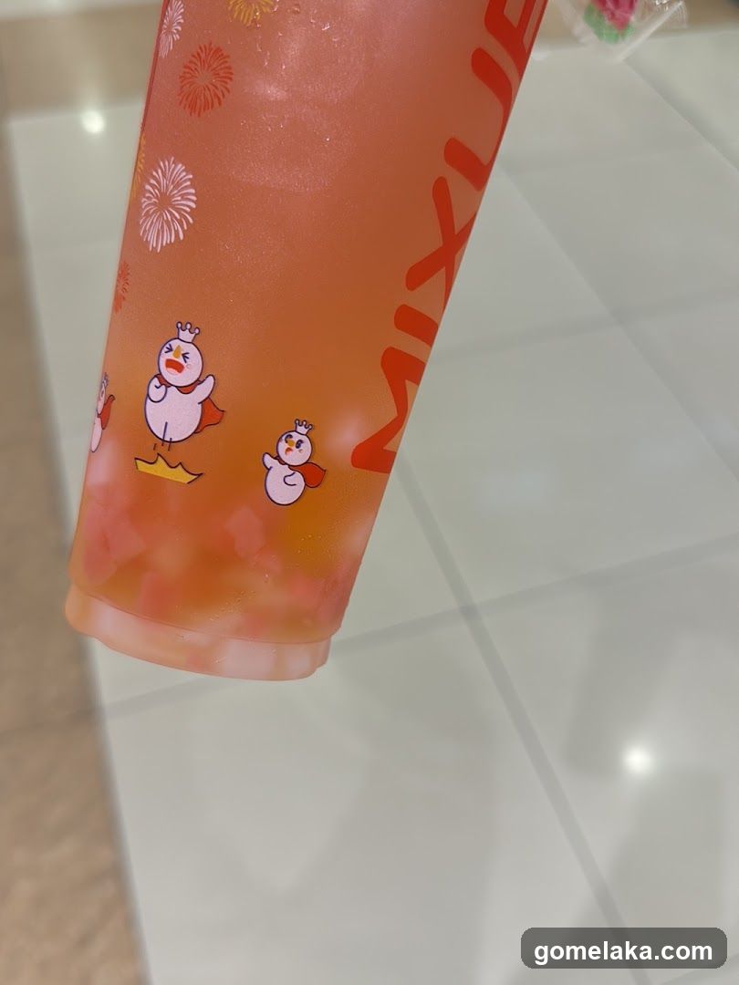 Orange beverage cup with cartoon characters