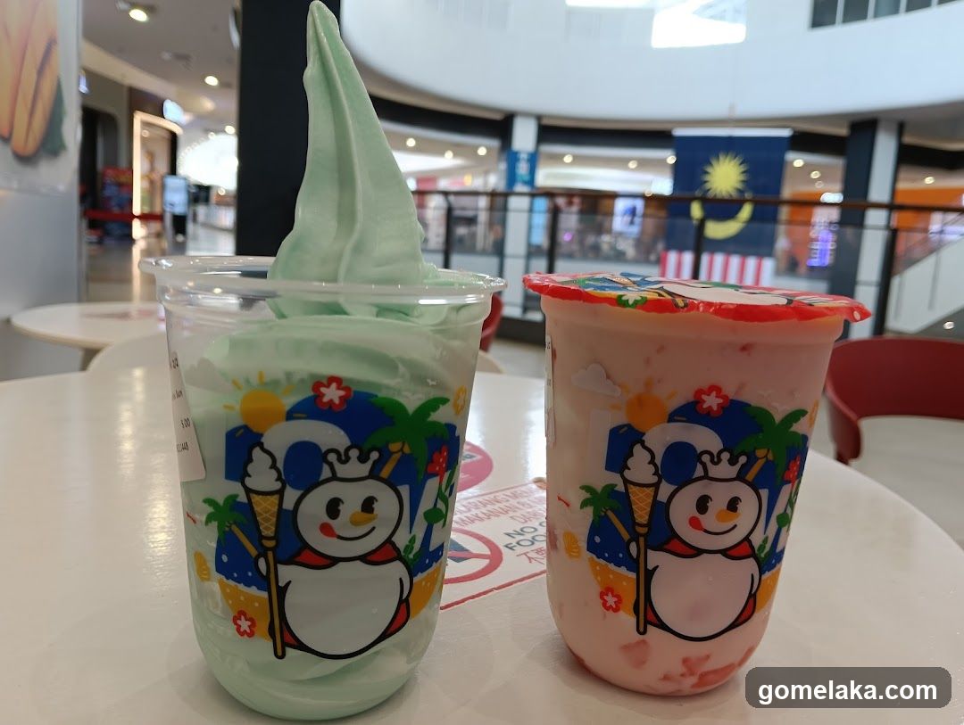Two soft-serve desserts in a shopping mall
