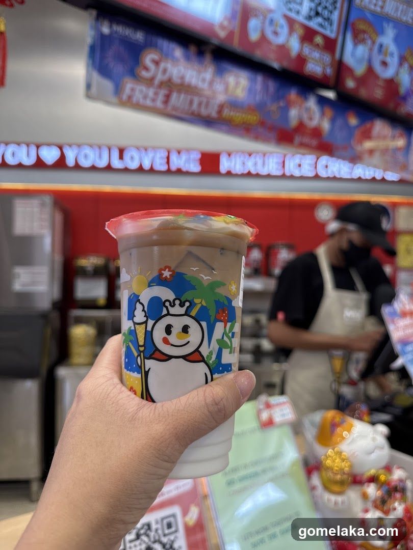 Hand holding ice cream cup in store