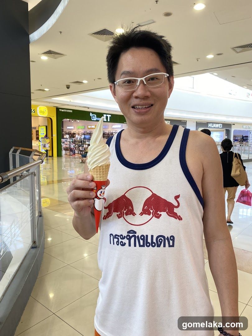 Man holding ice cream in shopping mall