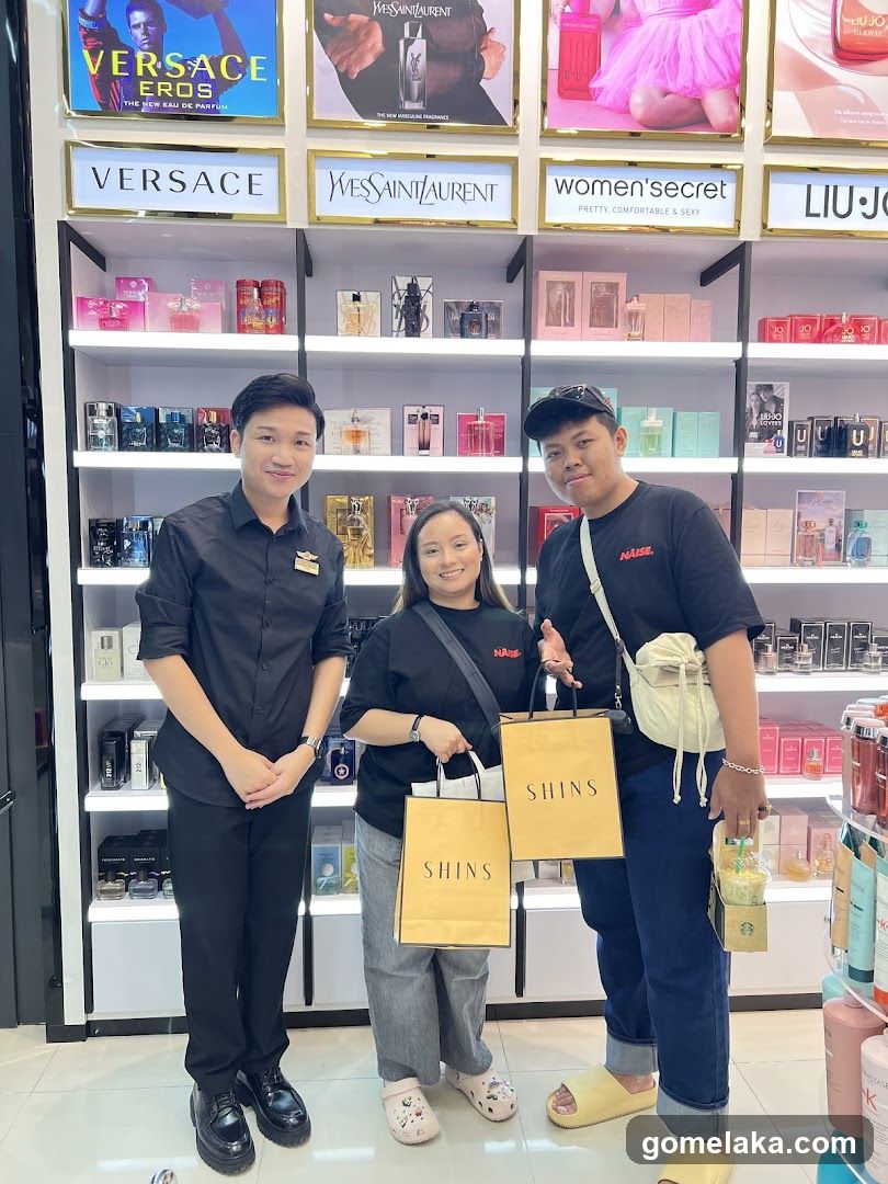 Three people in a perfume store