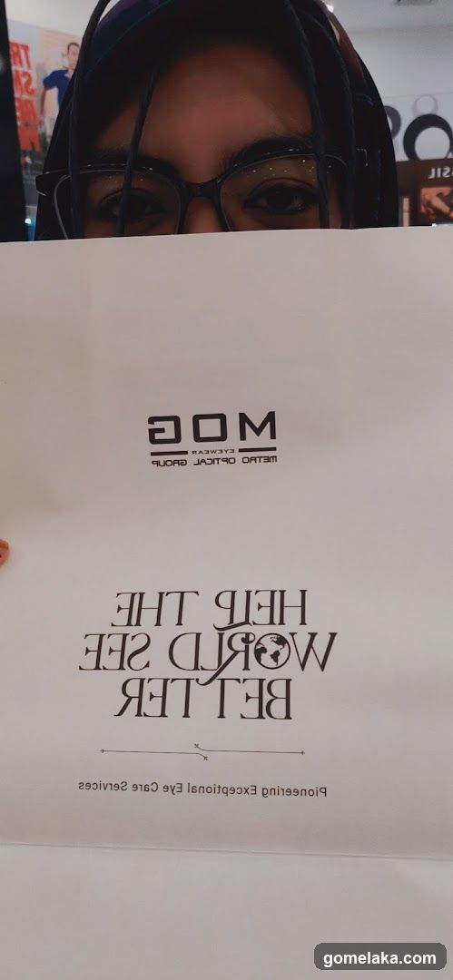 Person holding branded shopping bag