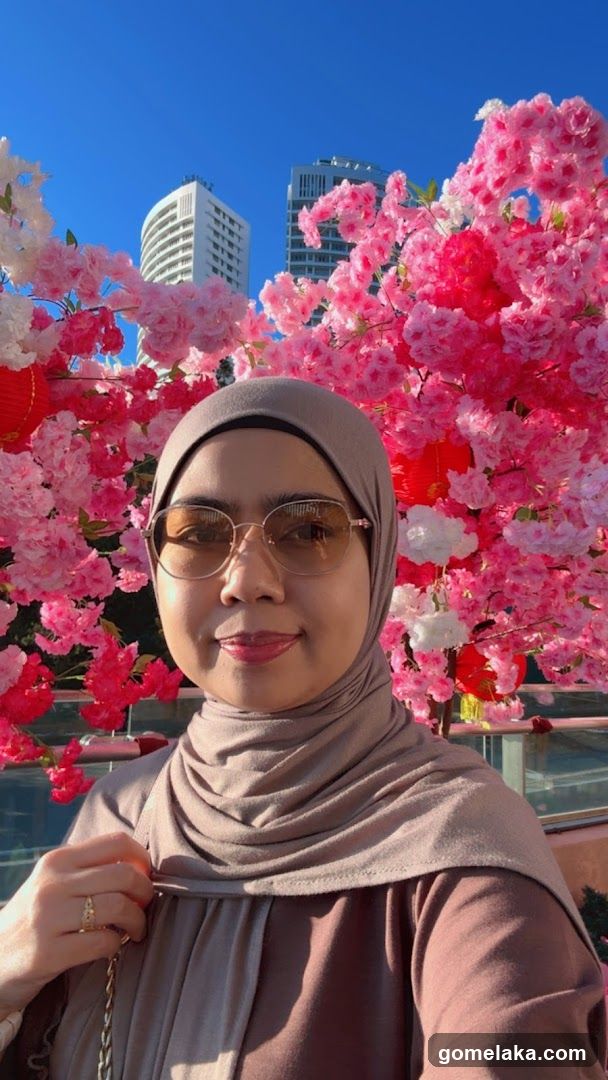 Person in front of floral display with city skyline