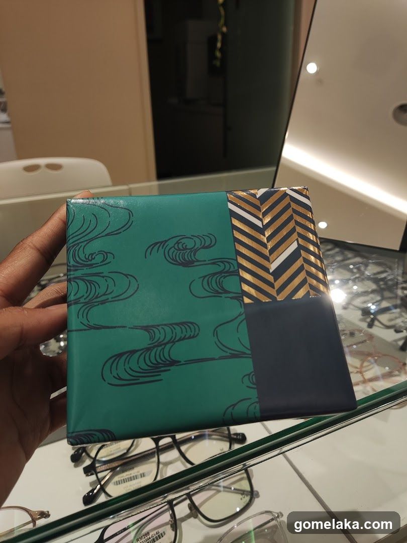 Hand holding a patterned box in store interior