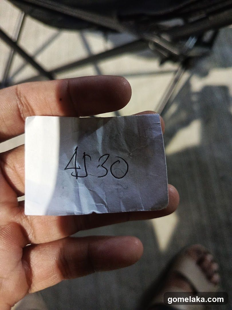 Hand holding note with number