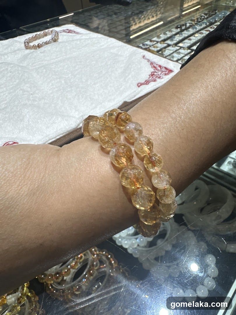 Hand wearing gemstone bracelet
