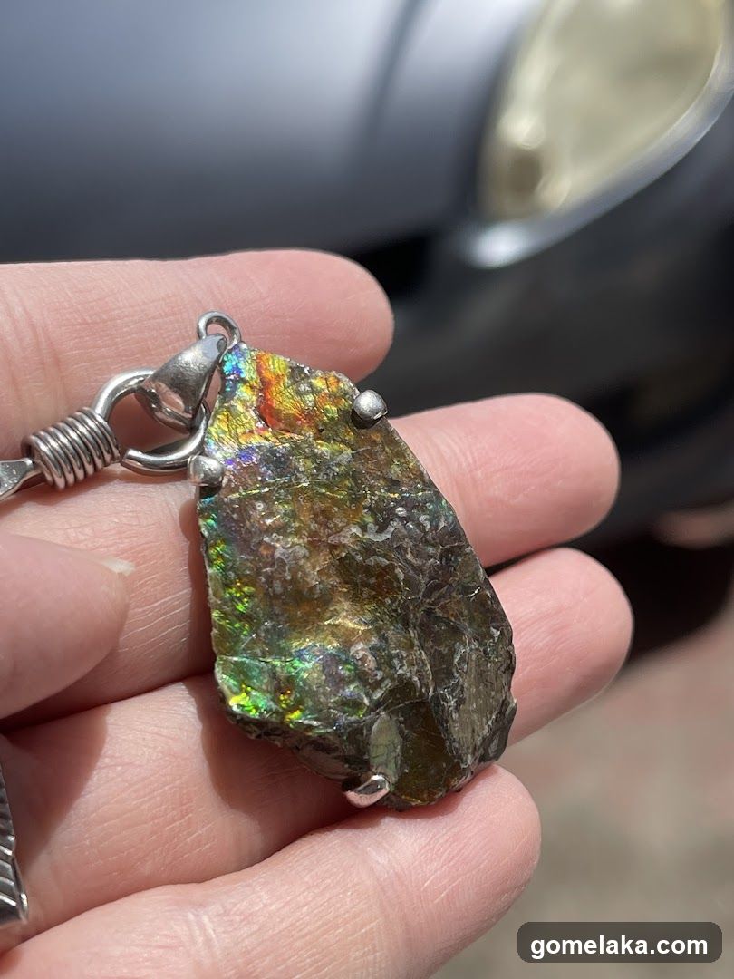 Hand Holding Ammolite Pendant