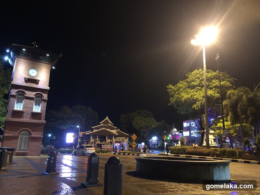 Nighttime urban scene with clock tower and street lighting