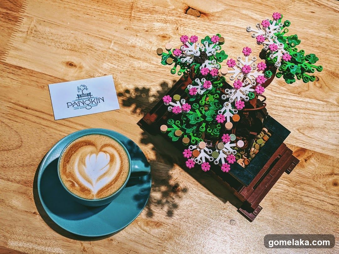 Coffee and LEGO plant on wooden table