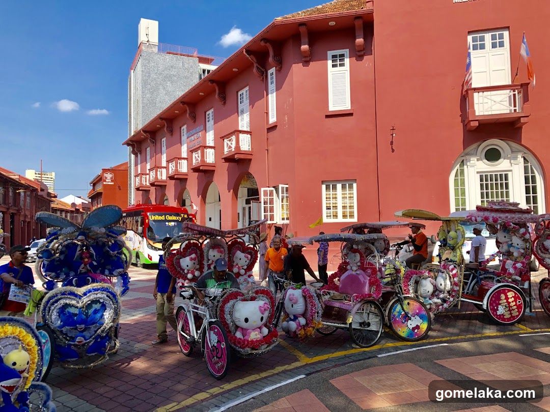 Street scene with Hello Kitty rickshaws and red building