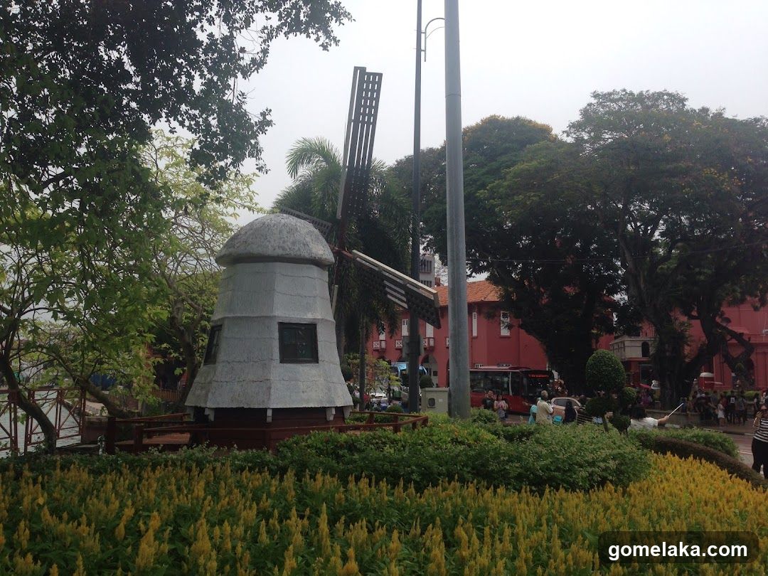 Outdoor Park Scene with Windmill and Red Building