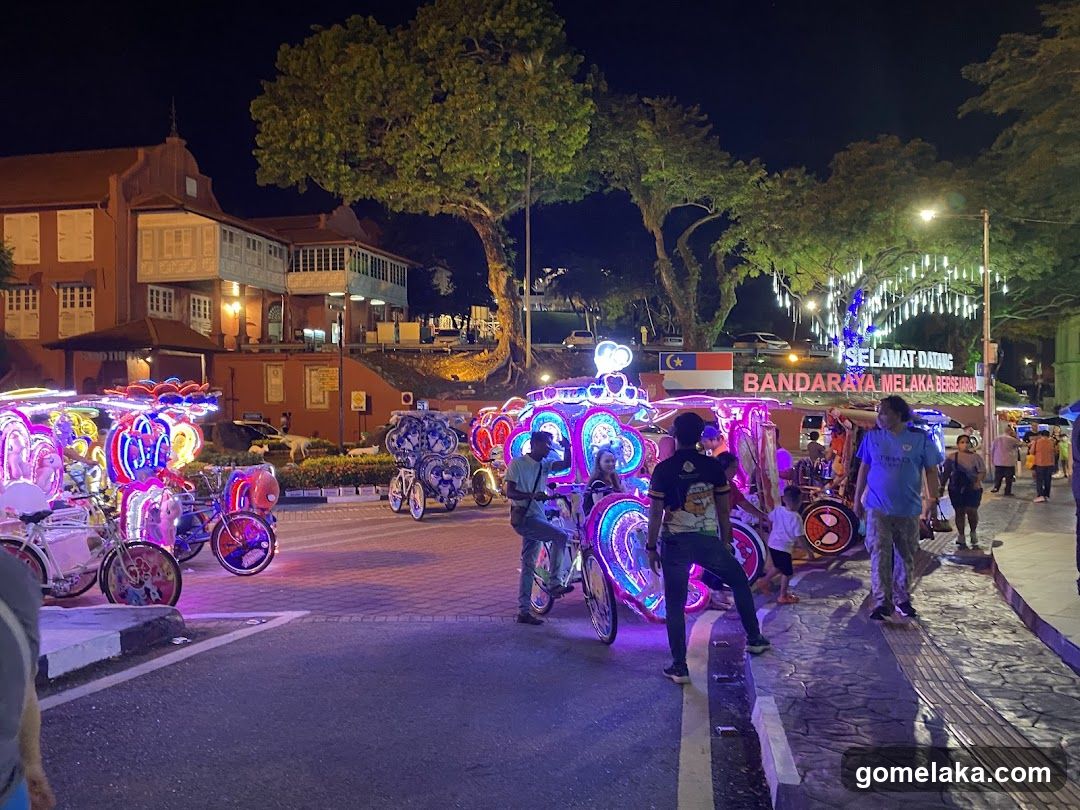 Nighttime Street Scene with Decorated Carts and Building