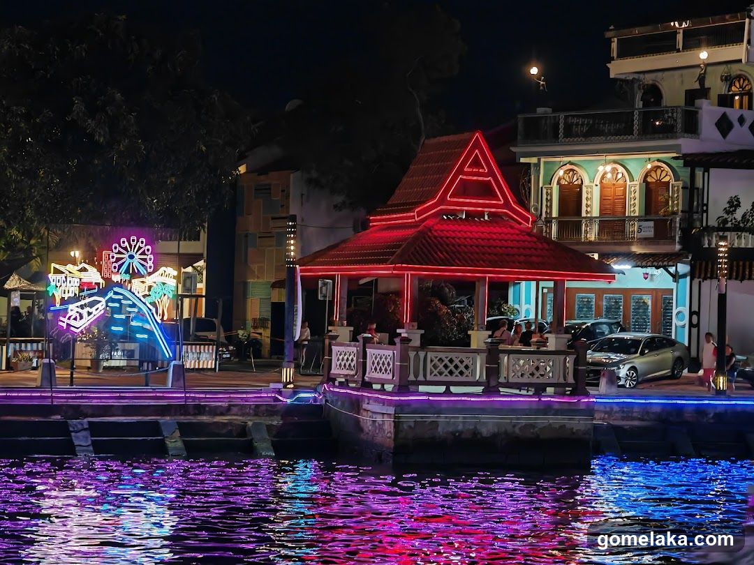 Nighttime waterfront scene with illuminated structures