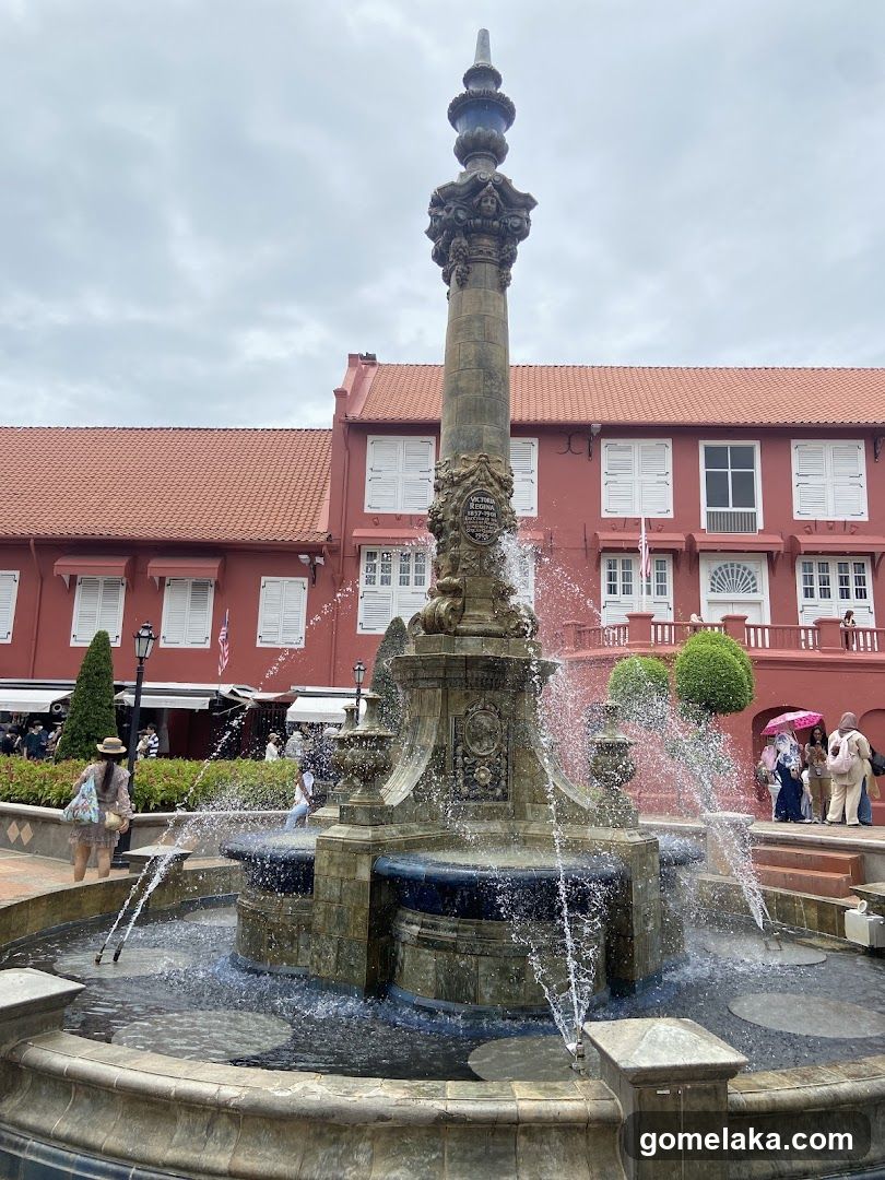 Fountain in Front of Red Building