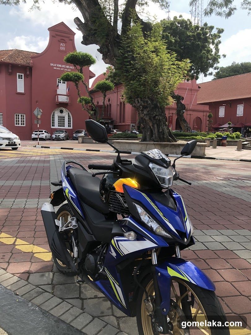 Motorcycle parked in front of red building