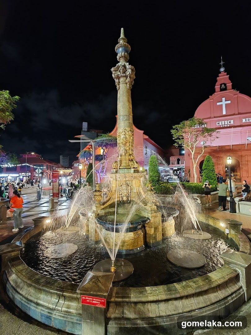 Nighttime fountain and church view