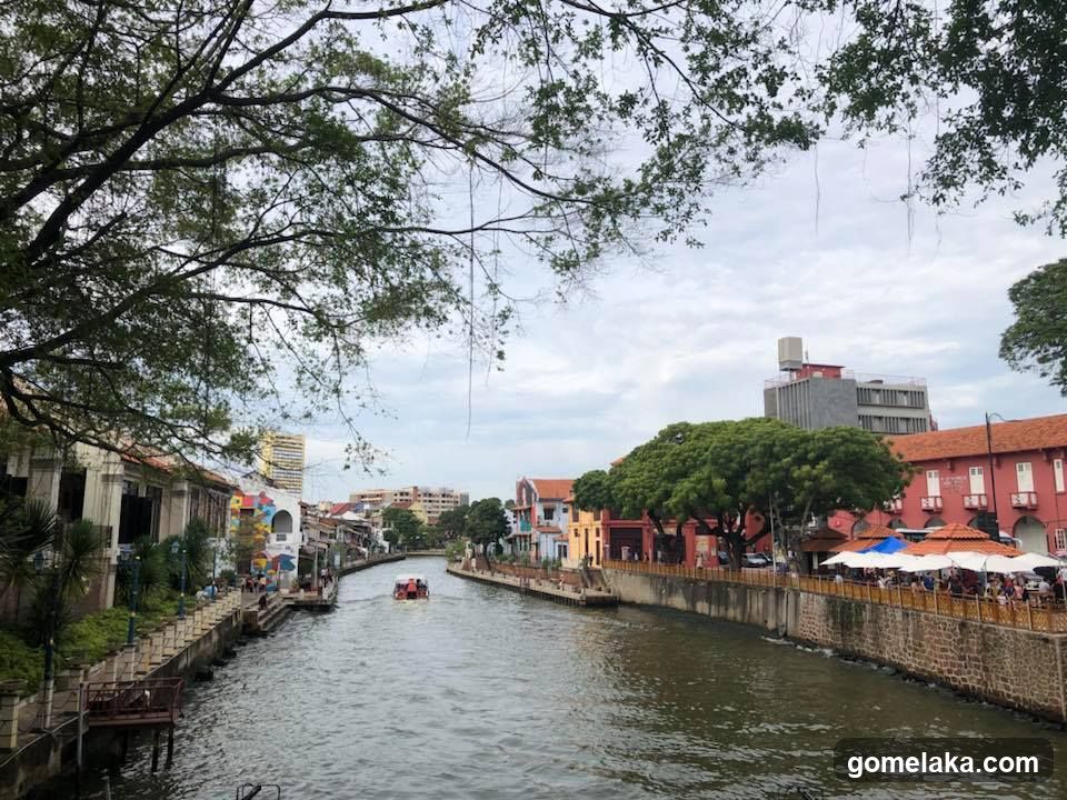 Riverfront Scene with Buildings and Trees