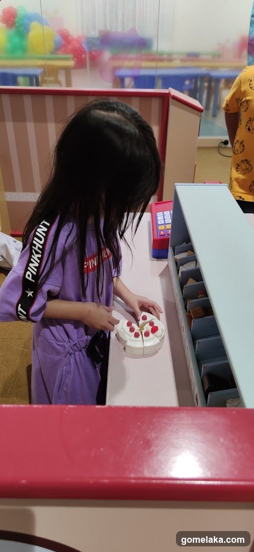 Child playing at toy store counter