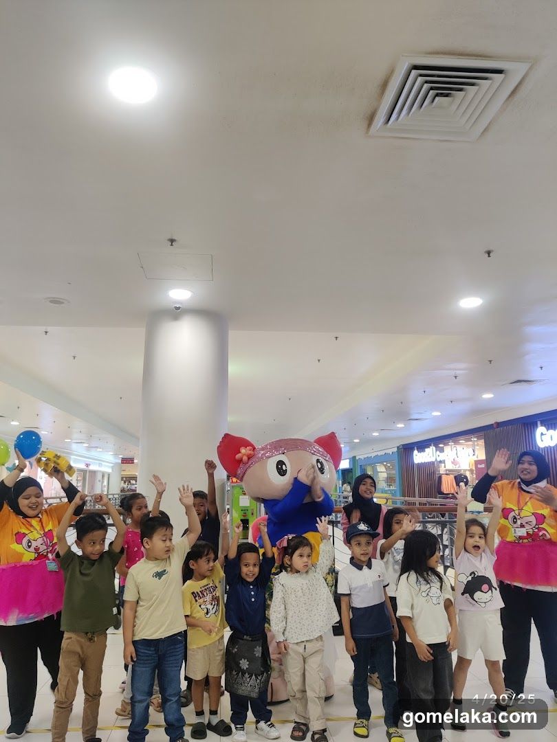 Children and staff with mascot in shopping mall