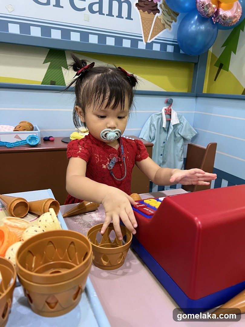 Child playing at toy ice cream shop