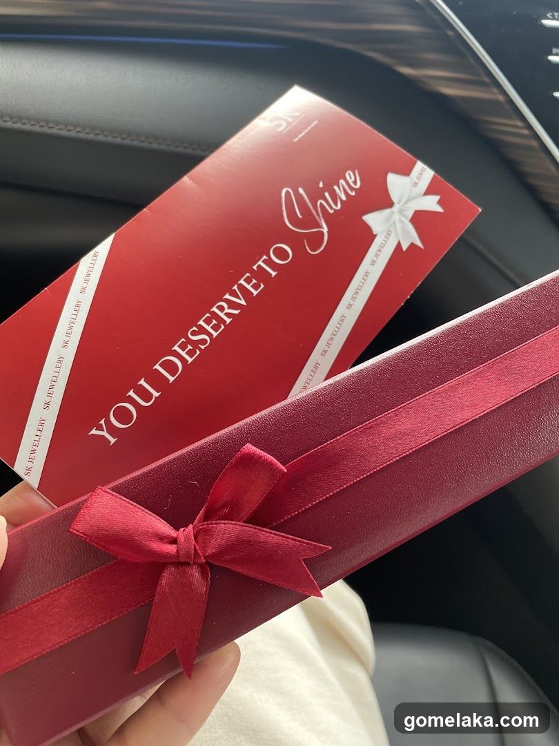 Hand Holding Gift Box and Card