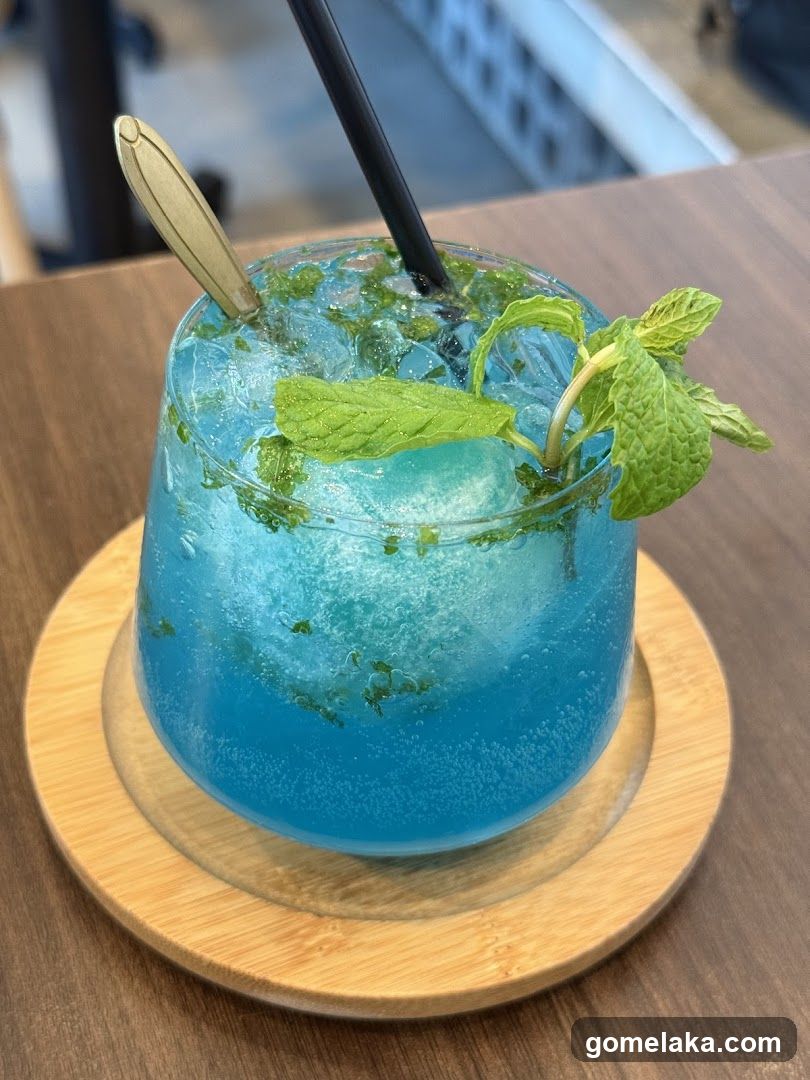 Blue beverage with mint garnish