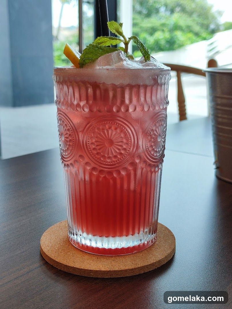 Pink beverage in decorative glass