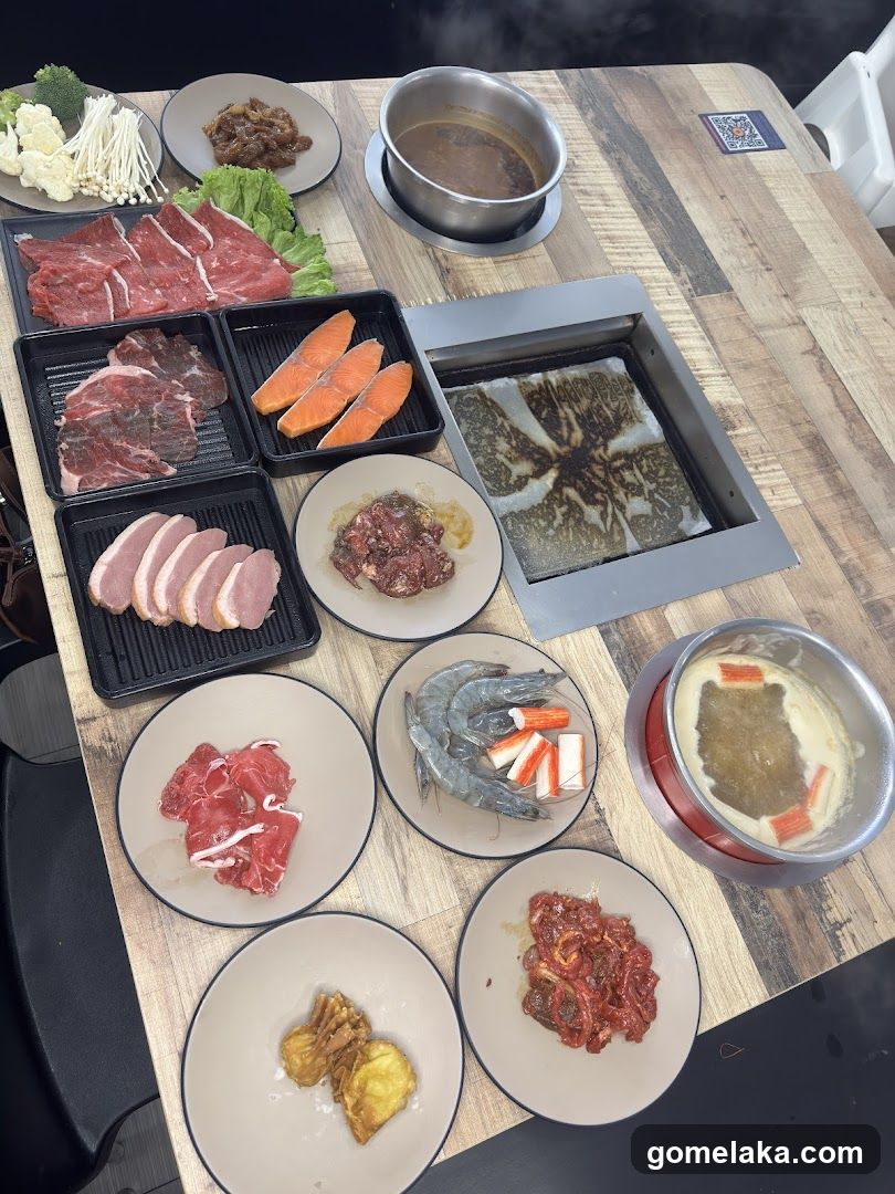 Table with hot pot and grill food