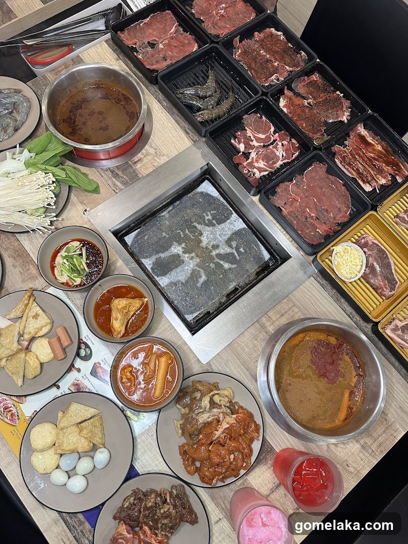 Grilled meat and hot pot dining setup