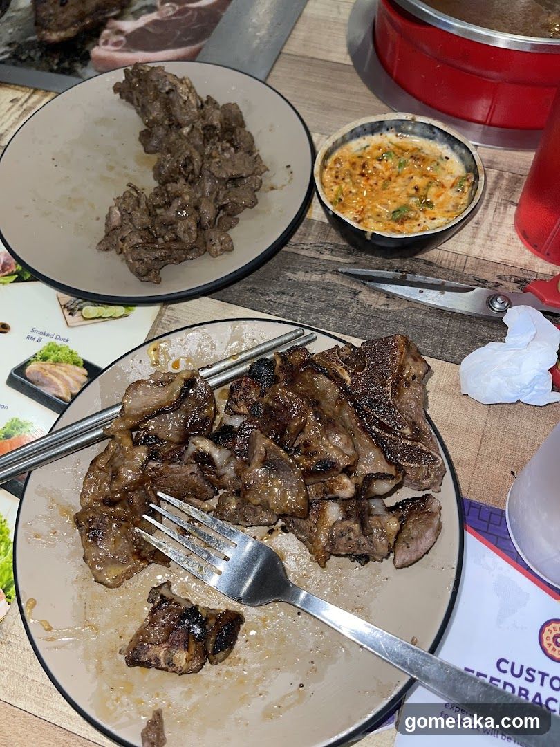 Dining Table with Grilled Meat and Condiments