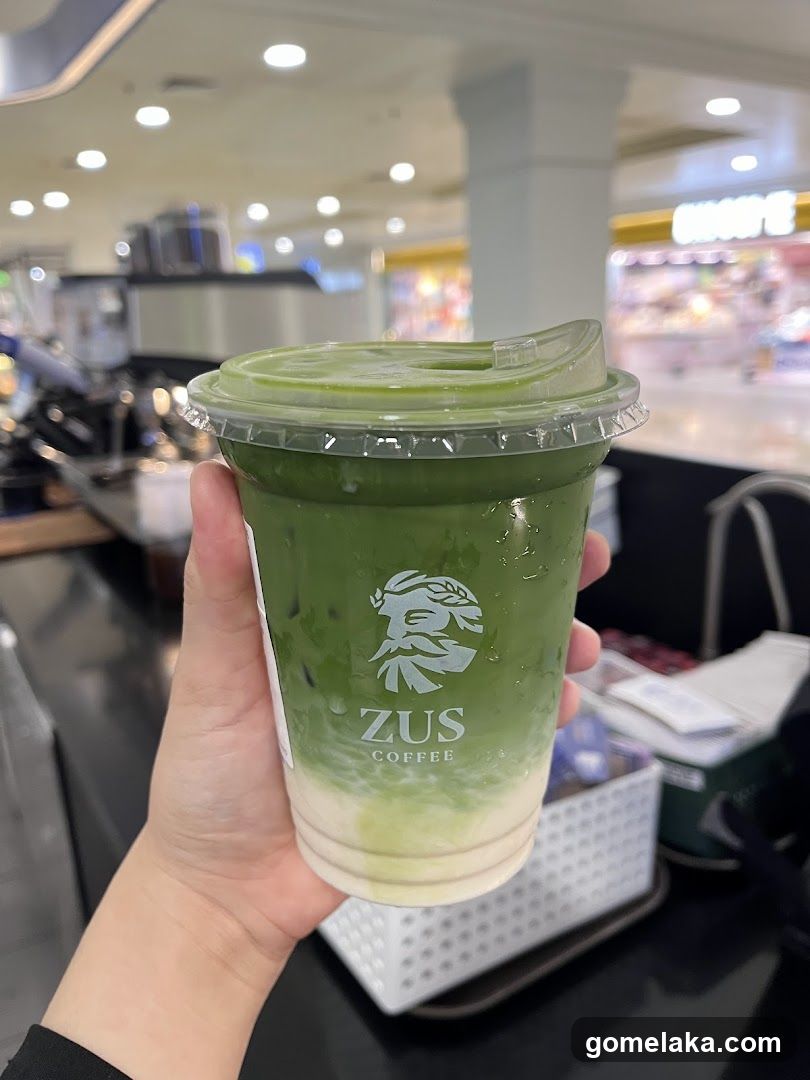 Hand holding a beverage cup