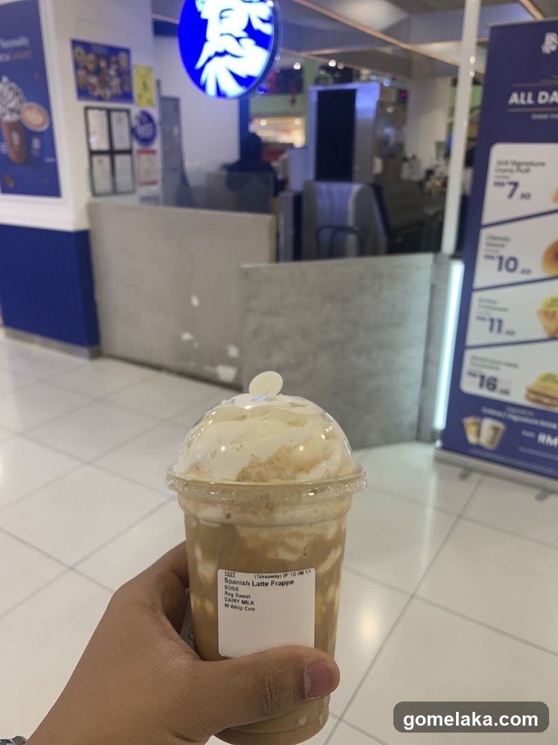 Hand holding beverage in mall