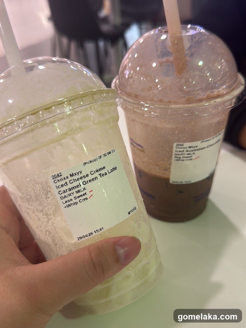 Two beverages in plastic cups with labels