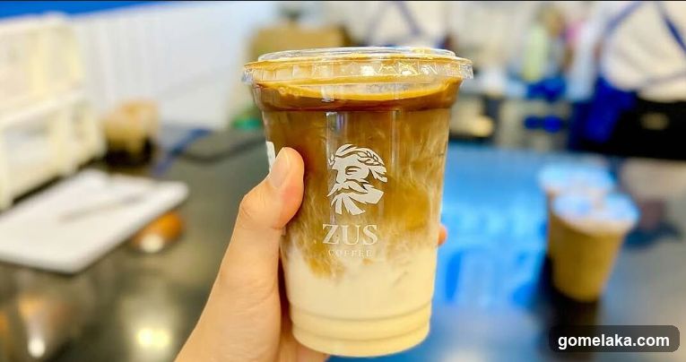 Hand holding coffee cup