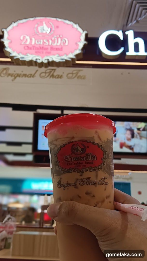 Hand holding a drink cup in a store interior