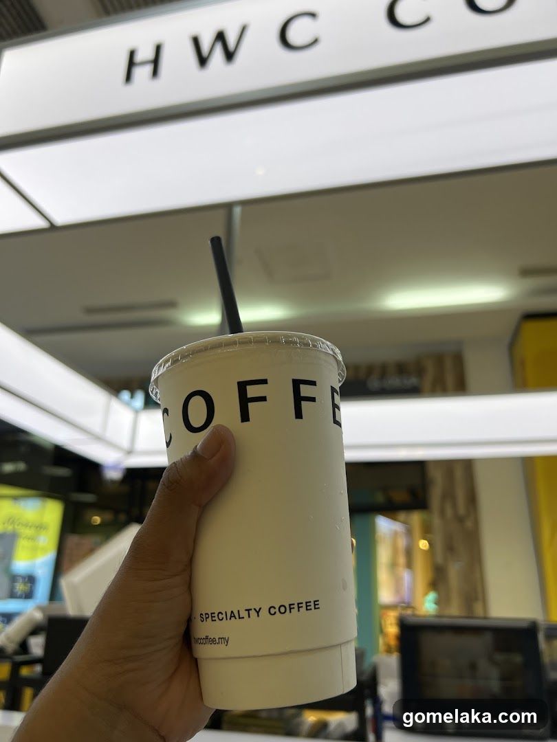 Hand holding coffee cup in store interior