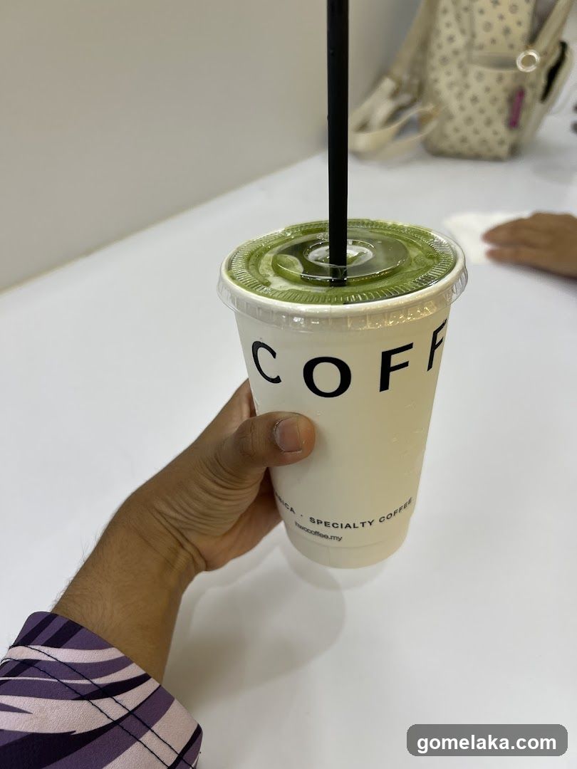 Hand holding coffee cup