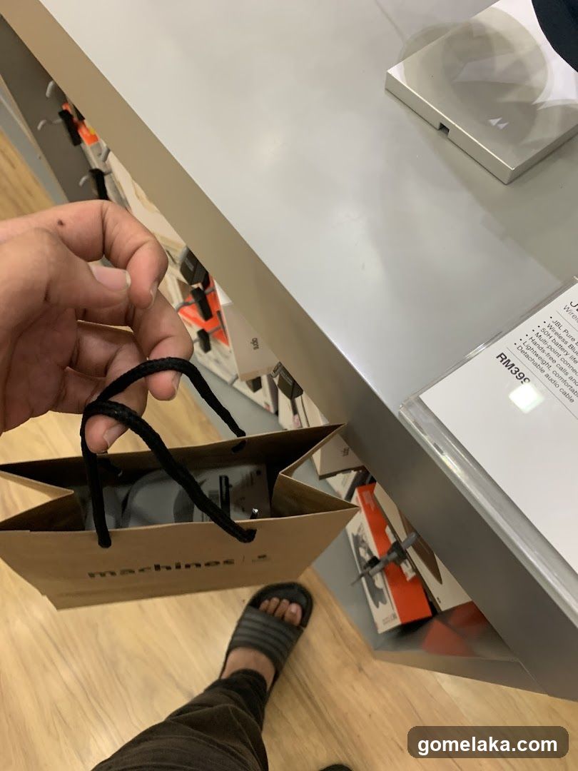 Hand holding shopping bag in store