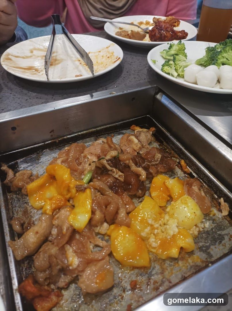 Grilled meat and vegetables on a hot plate