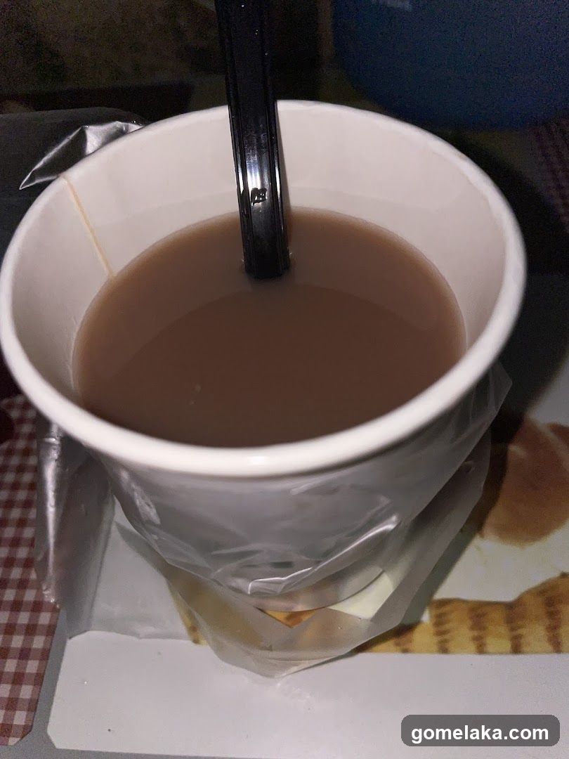 Cup of beverage with spoon