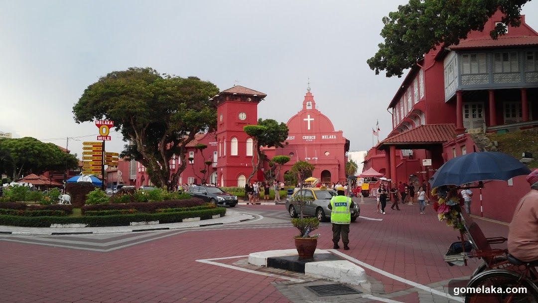 Red Building Complex with Pedestrians and Vehicles