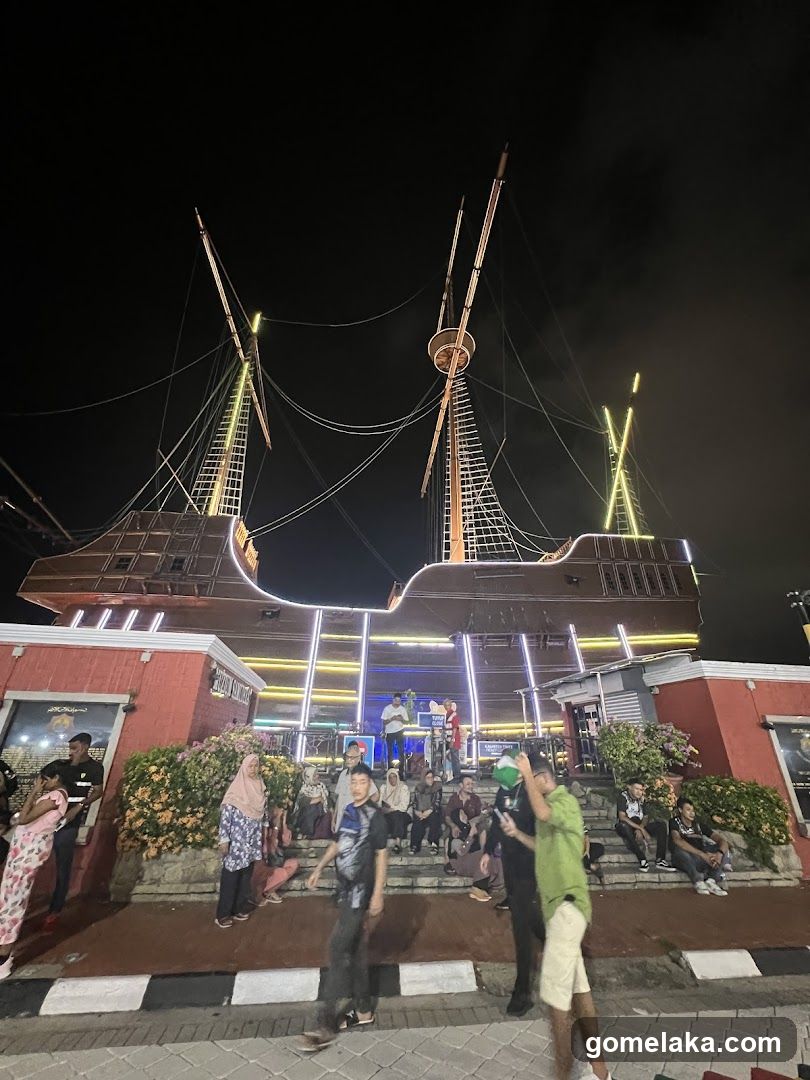 Nighttime outdoor scene with illuminated ship structure