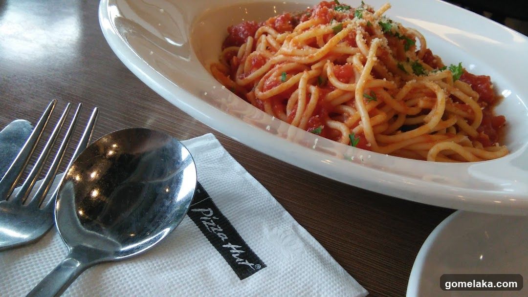 Spaghetti dish with cutlery and napkin