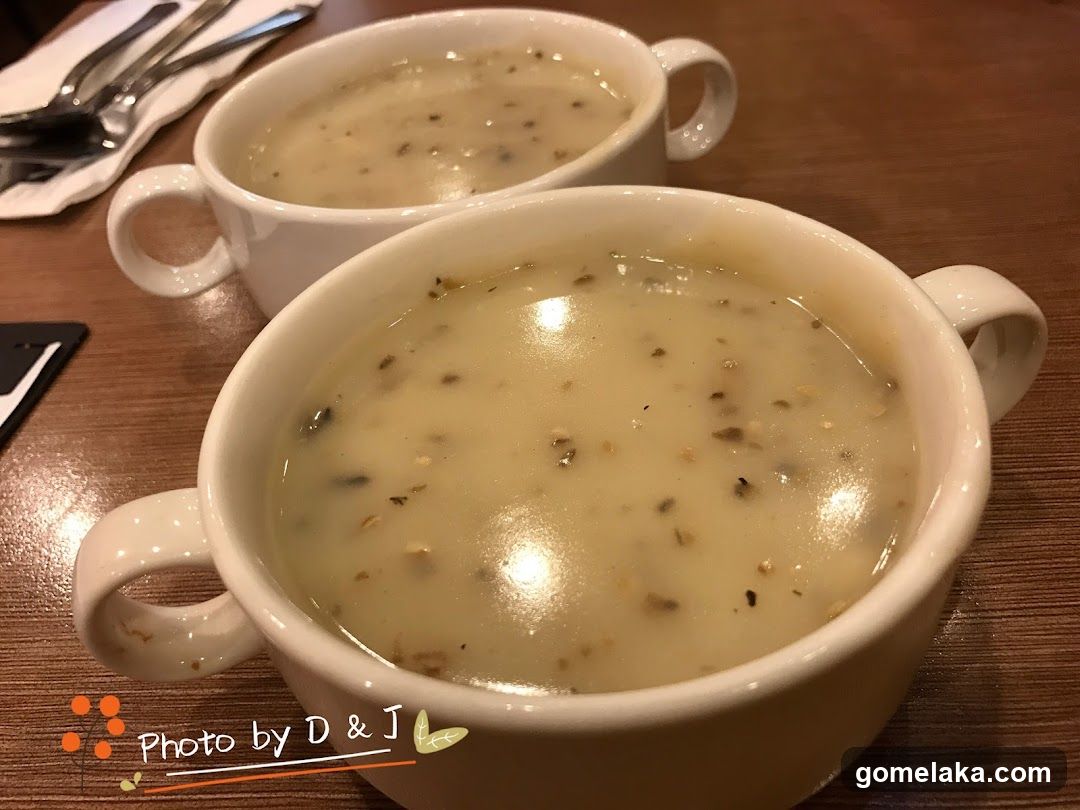 Two bowls of soup on a wooden table